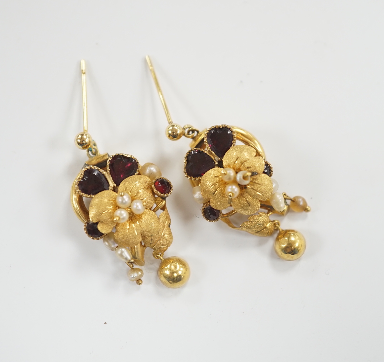 A pair of Victorian yellow metal, garnet and pearl set drop earrings, of foliate form, 31mm (adapted?), gross weight 6.8 grams.